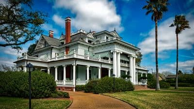 Historic Southern mansion with columns and manicured grounds